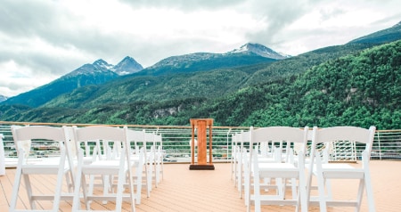 Chairs and a podium set up for a wedding ceremony at the Deck 10 Aft Overlook on the Disney Magic
