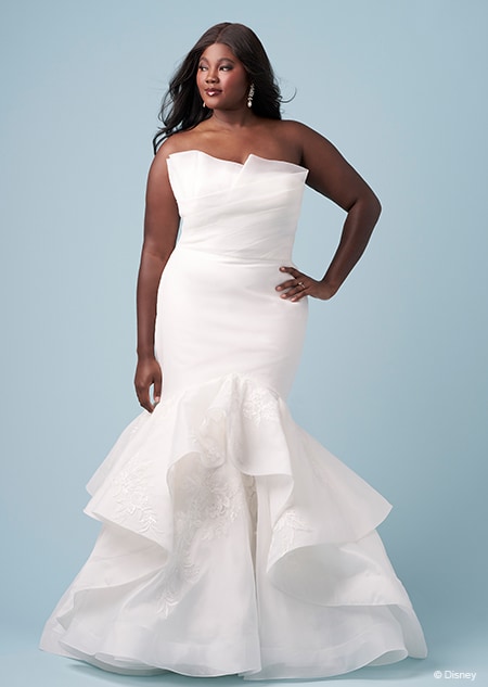 A bride wearing a strapless Tiana inspired trumpet gown featuring sheer fabric over a sweetheart neckline