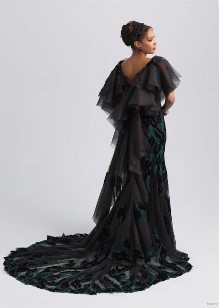 The back of a gauzy black and green wedding dress featuring a long train inspired by Maleficent from Sleeping Beauty The back of a gauzy black and green wedding dress featuring a long train inspired by Maleficent from Sleeping Beauty