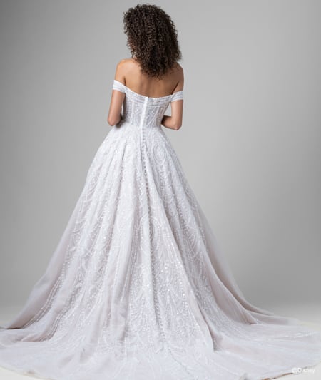 The back of a bride wearing a Jasmine inspired A line gown featuring beading, a train and off the shoulder sleeves