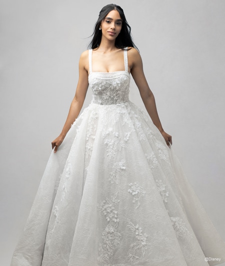 The front of a bride wearing a Snow White inspired ball gown featuring lace detail and a square neckline The front of a bride wearing a Snow White inspired ball gown featuring lace detail and a square neckline