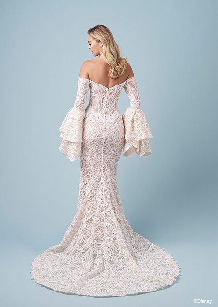 The back of a bride wearing a strapless Jasmine inspired mermaid wedding gown featuring lace and ruffled off the shoulder sleeves