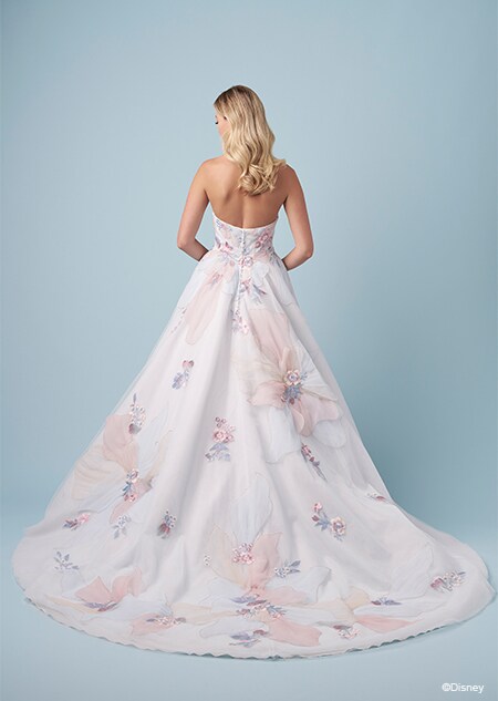 The back of a bride wearing a strapless Rapunzel inspired A line wedding gown featuring large embroidered flowers