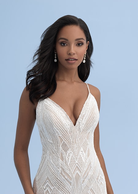 A close up of a wedding dress with a sweetheart neckline and skinny straps