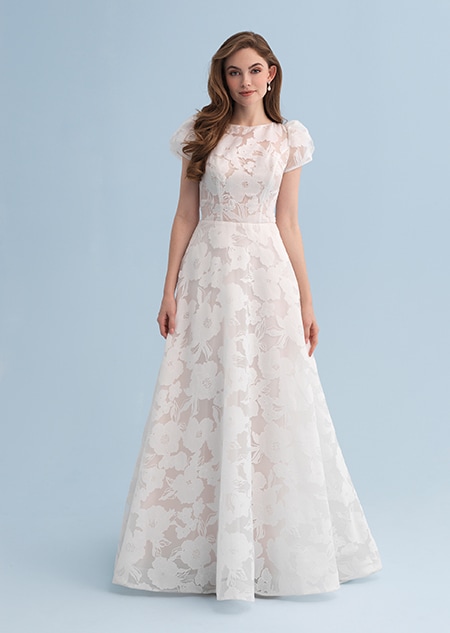 A woman wearing a wedding dress covered with a flowery pattern A woman wearing a wedding dress covered with a flowery pattern