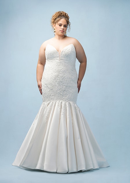 The front of a bride wearing an Ariel inspired mermaid gown featuring a sweetheart neckline and beading
