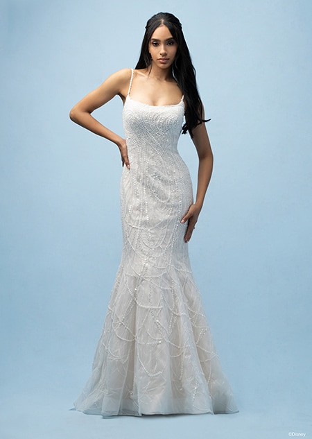 The front of a bride wearing a Tiana inspired sheath gown featuring beading, sequins and a spaghetti strap neckline The front of a bride wearing a Tiana inspired sheath gown featuring beading, sequins and a spaghetti strap neckline