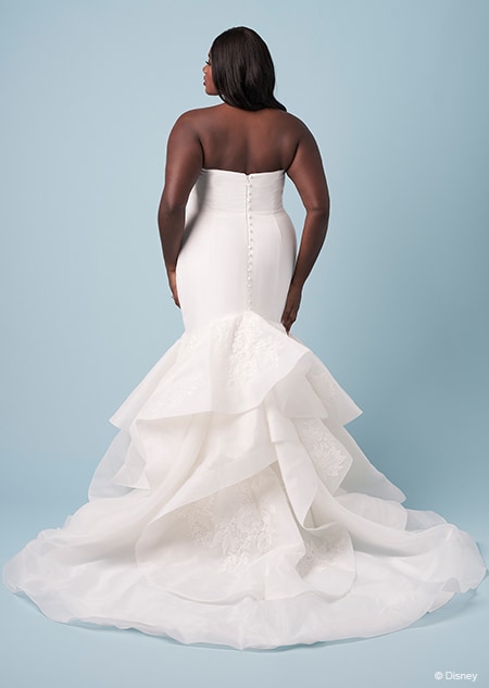 The back of a bride wearing a strapless Tiana inspired trumThe back of a bride wearing a strapless Tiana inspired trumpet gownpet gown