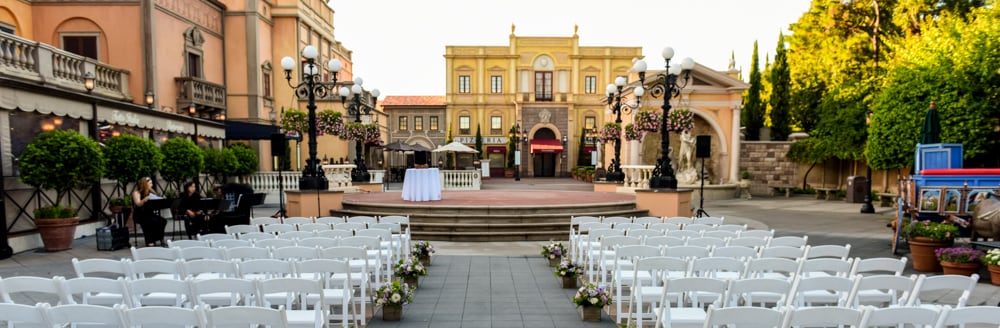 A long aisle leading towards a raised platform in the middle of a courtyard