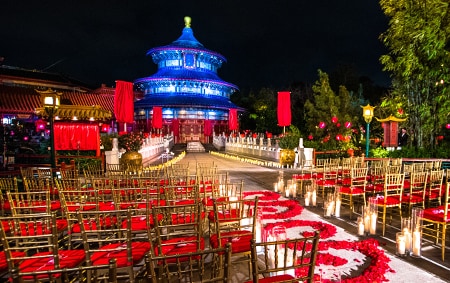 A wedding ceremony setting decorated with candles and an aisle of rose petals at the China Pavilion