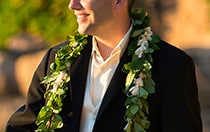 A man wearing a lei around his suit