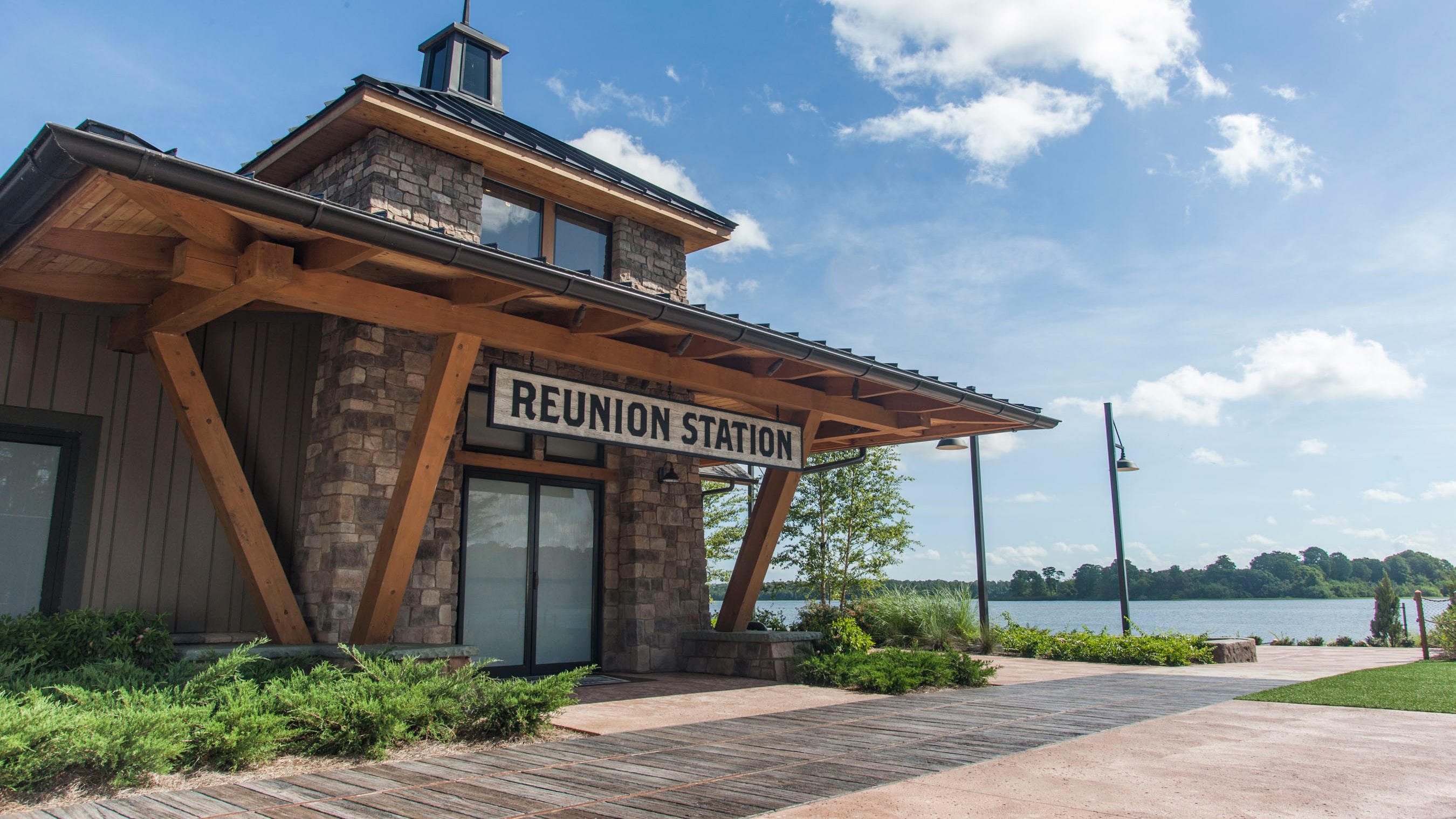 A lakefront building with a sign that reads 'Reunion Station'