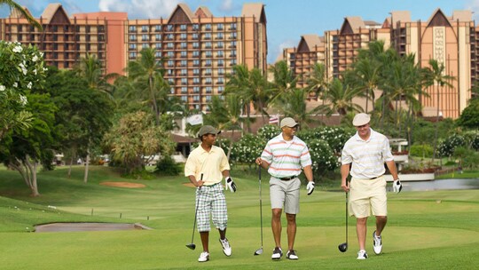 Three male golfers on a golf course near Aulani, A Disney Resort & Spa