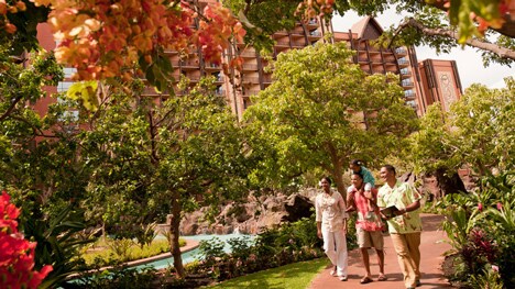 A Cast Member leads a family on a tour around the grounds at Aulani, A Disney Resort & Spa