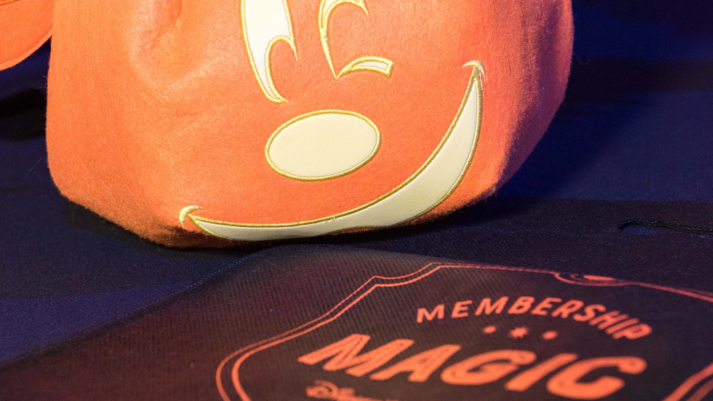 A trick or treat bag shaped like a jack o lantern with Minnie Mouse's face