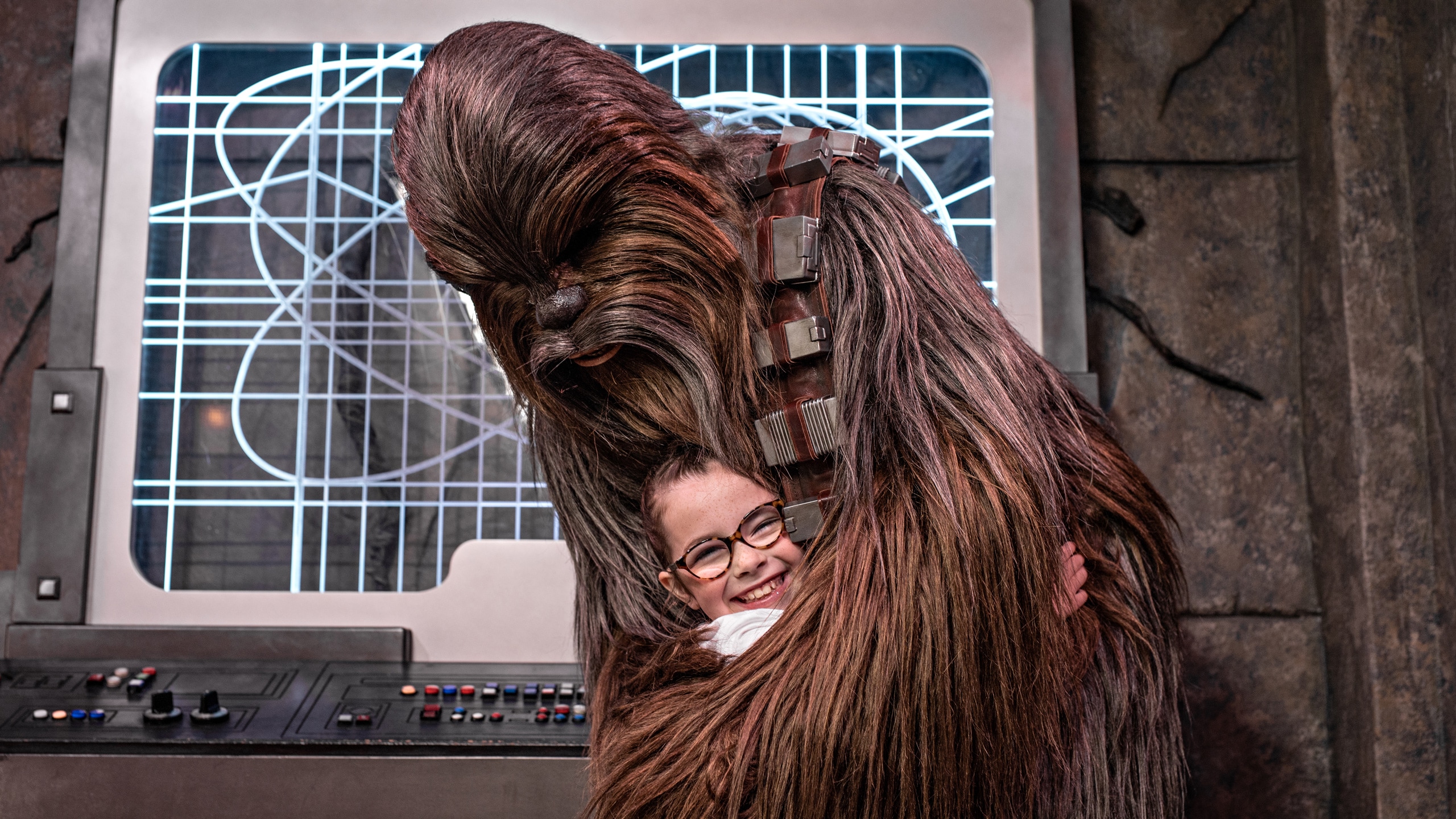 Chewbacca hugs a young girl in Star Wars Launch Bay