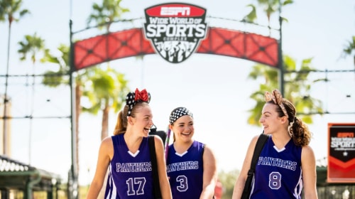 Three athlete Guests sharing a laugh as they walk through the ESPN Wide World of Sports Complex at Walt Disney World Resort 