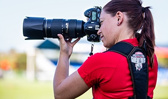 A photographer takes a photo on the field