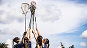 Disney High School Spring Training Event A long-distance relay runner hands a baton to his teammate