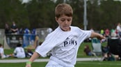 Challenge 3v3 National Championship A little boy kicks a soccer ball