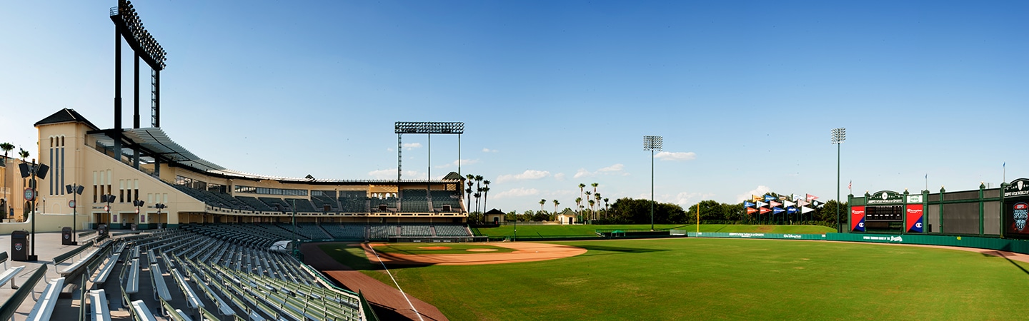 In a sports complex, uniformed team members join their raised arms in a gesture of solidarity.